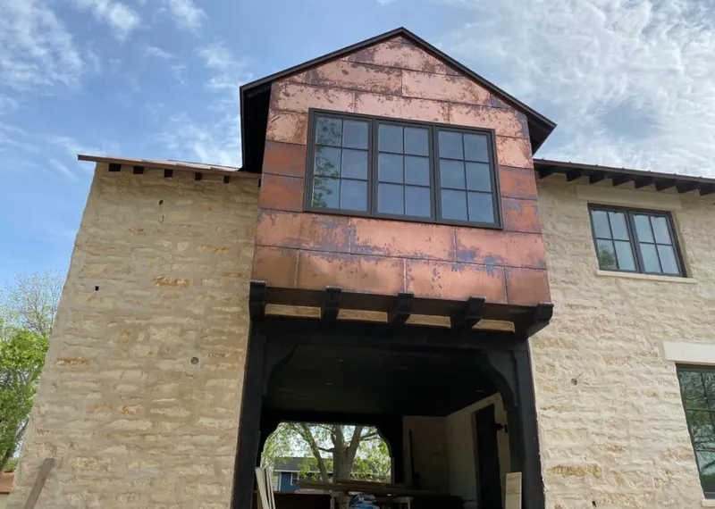 Copper metal panel facade on a stone building for Skylight Installation in Brownsville